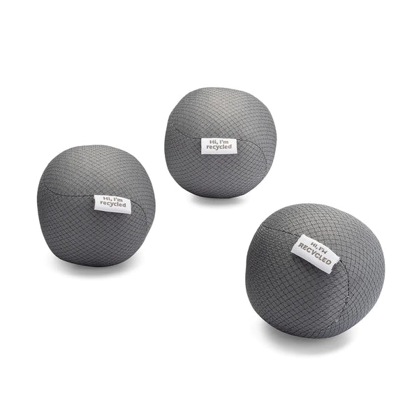 three gray dryer balls made from recycled water bottles. each has a tag on it that says "hi I'm recycled". on a white background. three gray dryer balls made from recycled water bottles. each has a tag on it that says "hi I'm recycled". on a white background.
