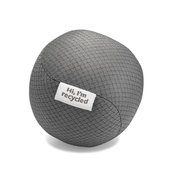 close up of one gray dryer ball made from recycled water bottles. each has a tag on it that says "hi I'm recycled". on a white background. close up of one gray dryer ball made from recycled water bottles. each has a tag on it that says "hi I'm recycled". on a white background.