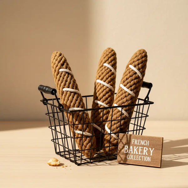 Decorative bread loaves made of rope in a wire basket with a 'French Bakery Collection' sign on a beige background.
