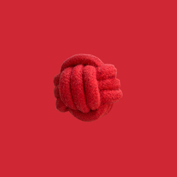 Red rope knot ball on a red background