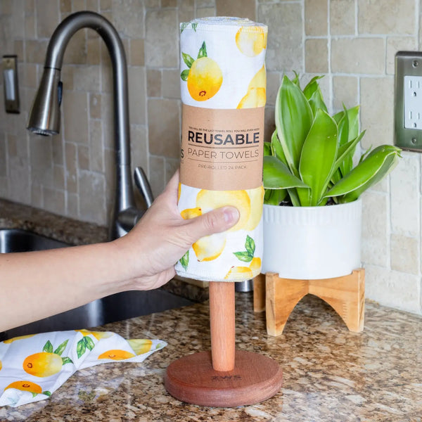 Reusable paper towels with lemon design held by a hand in a kitchen.