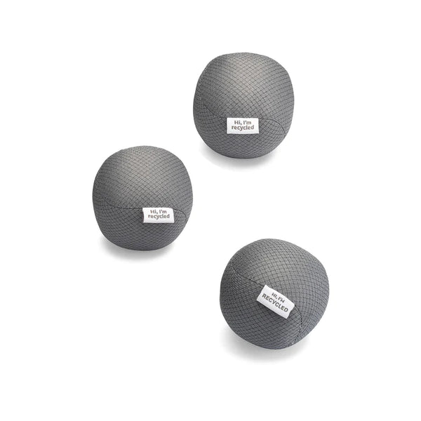 three gray dryer balls made from recycled water bottles. each has a tag on it that says "hi I'm recycled". on a white background.
